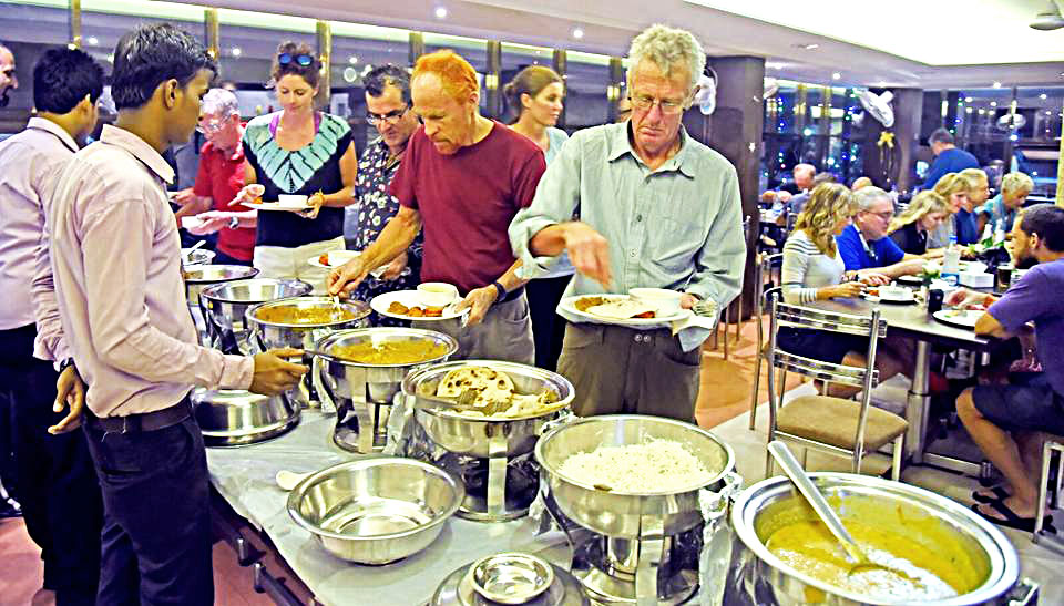 Foreign tourists enjoying buffet dinner at Hotel Alankar Devgad